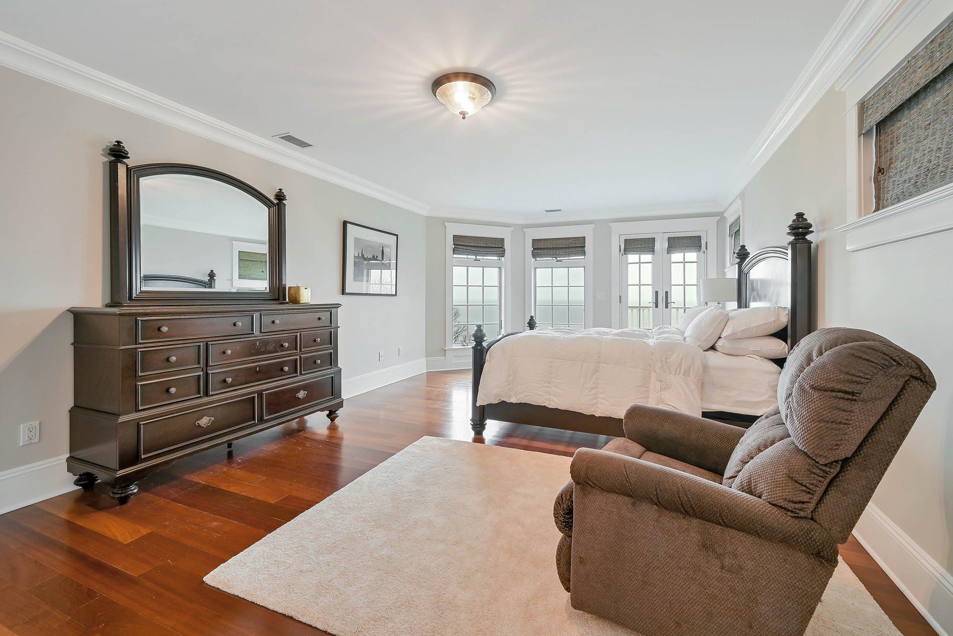580 Lloyds Lane Mattituck, NY 11952 - Photo 25 of 30 Bedroom with french doors, crown molding, and dark wood-type flooring