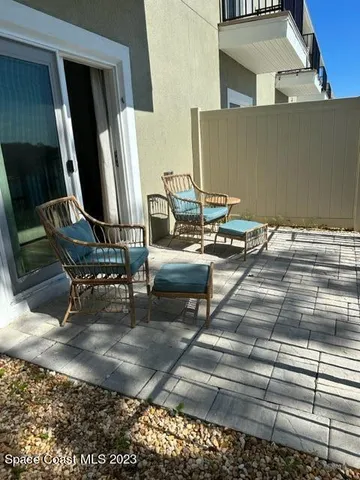 a view of a lake with wooden stairs and bridge and palm trees