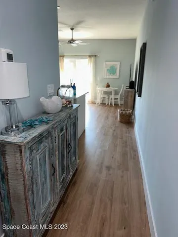 a kitchen with a table chairs and a chandelier