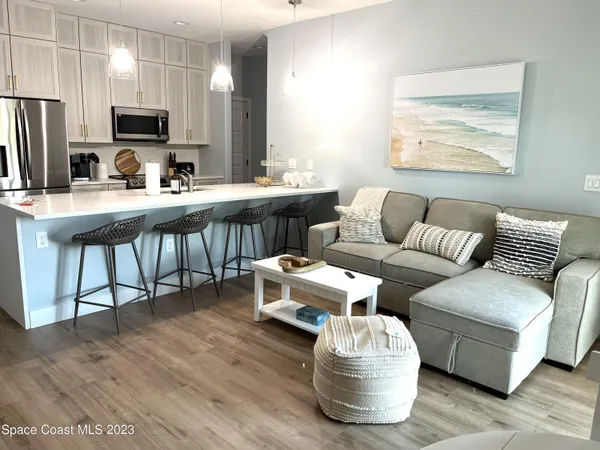 a kitchen with a table chairs and a wooden floor