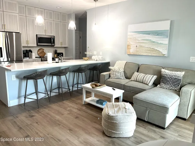a kitchen with a table chairs and a wooden floor