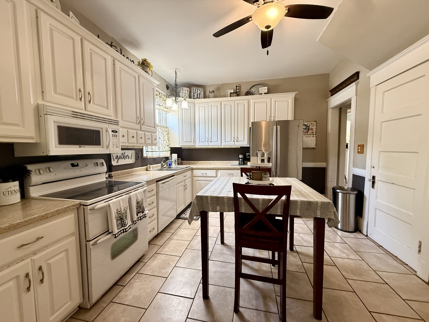 222 West Main Street Clinton, IL 61727 - Photo 11 of 25 a kitchen with stainless steel appliances kitchen island granite countertop a stove a sink and a refrigerator