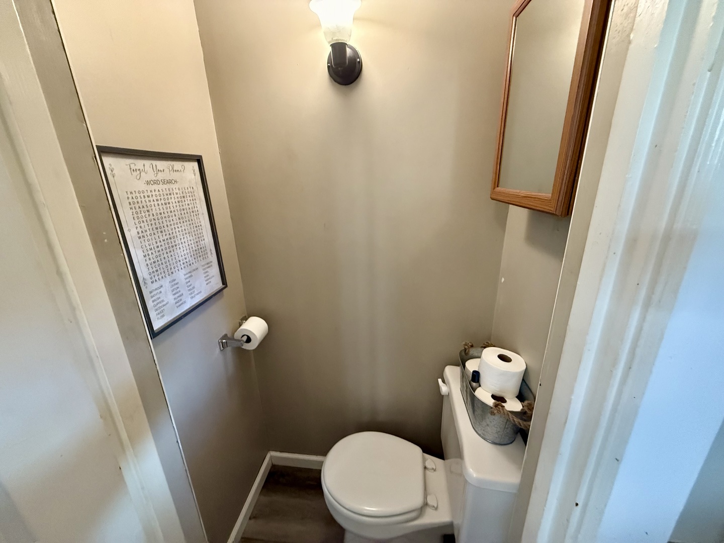 222 West Main Street Clinton, IL 61727 - Photo 12 of 25 a white toilet sitting next to a small sink