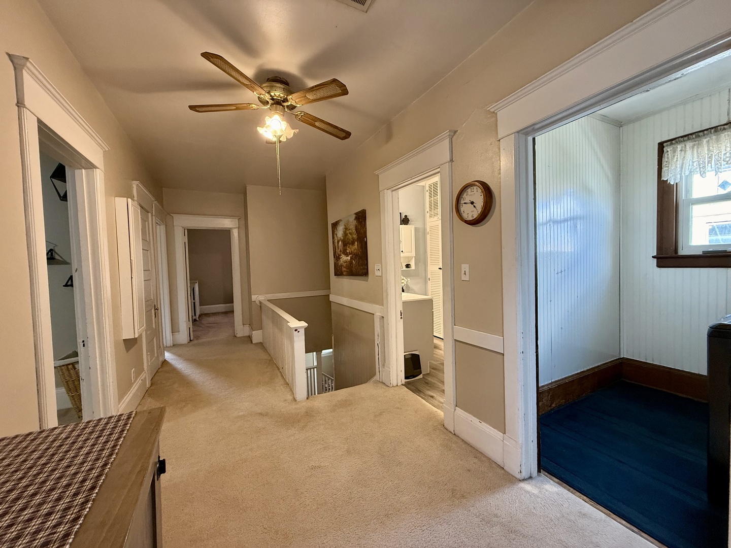 222 West Main Street Clinton, IL 61727 - Photo 13 of 25 a view of a livingroom with a chandelier fan and a bathroom