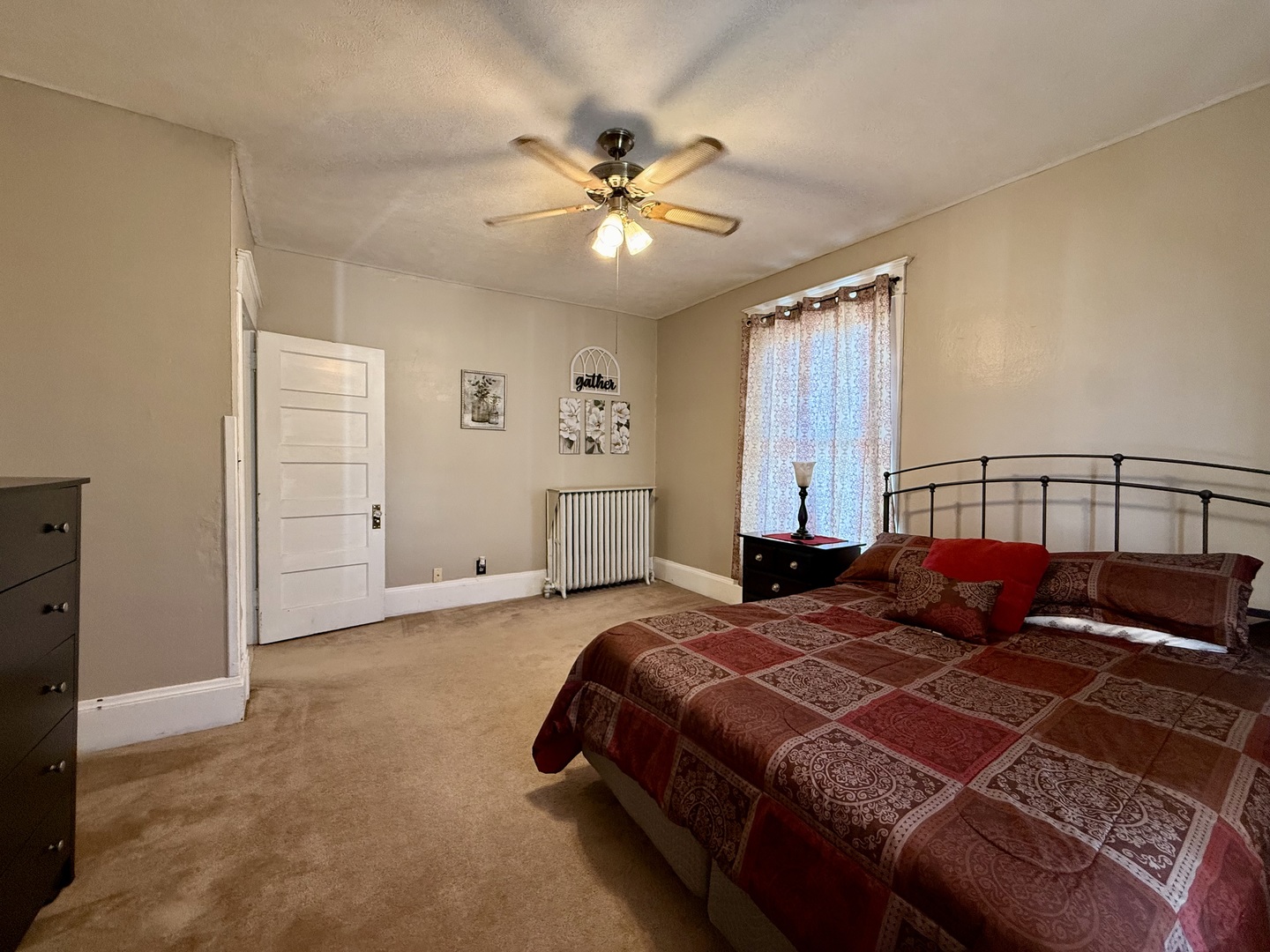222 West Main Street Clinton, IL 61727 - Photo 17 of 25 a bedroom with a large bed and a chandelier