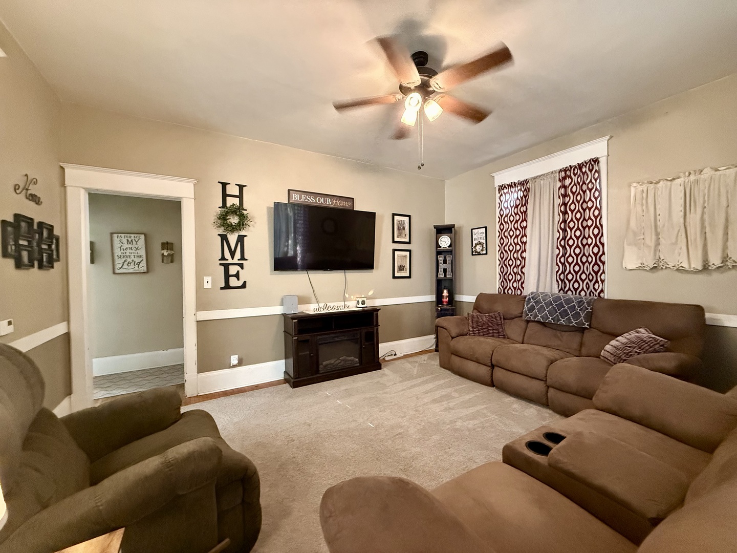 222 West Main Street Clinton, IL 61727 - Photo 7 of 25 a living room with furniture and a flat screen tv