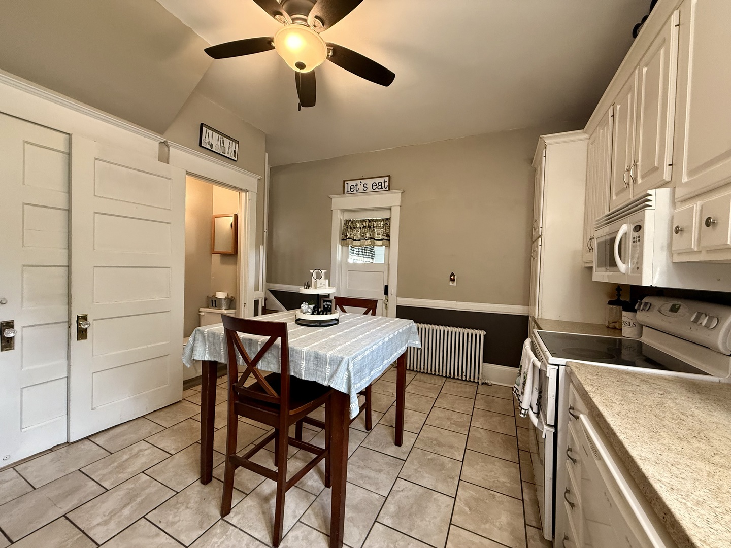 222 West Main Street Clinton, IL 61727 - Photo 10 of 25 a kitchen with stainless steel appliances granite countertop a sink a stove and a refrigerator