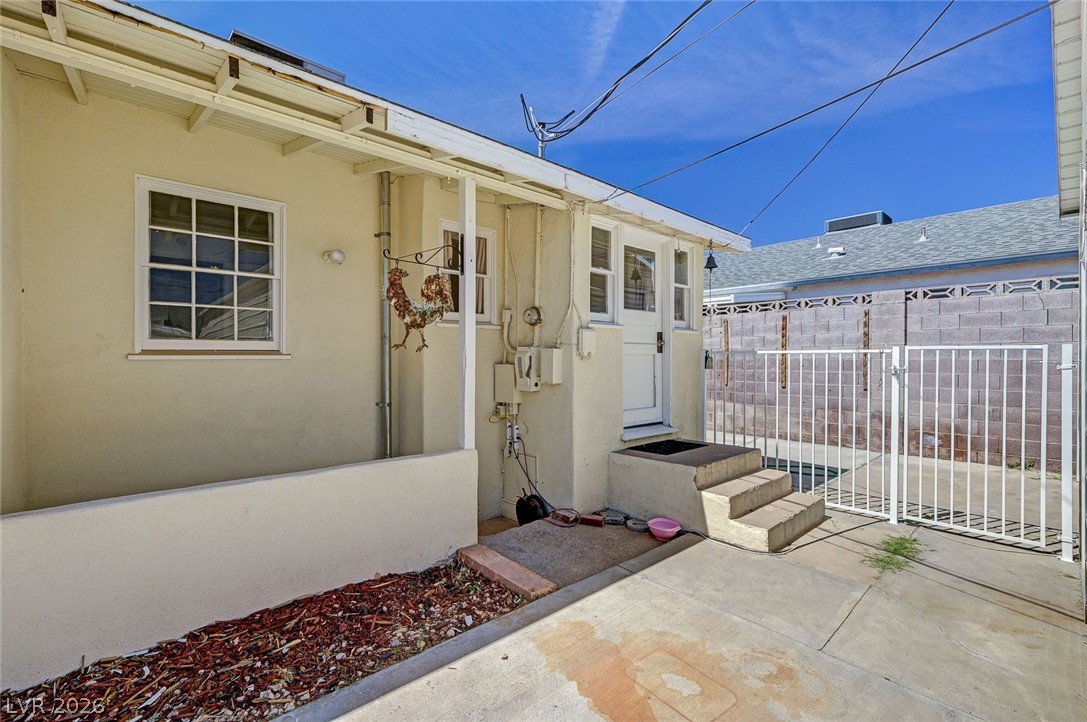 629 L Avenue Boulder City, NV 89005 - Photo 31 of 46 Property from rear entrance featuring stucco siding and a gate