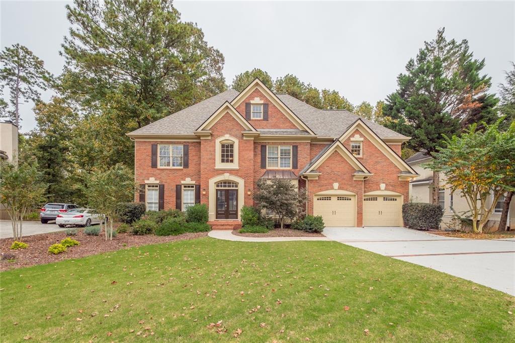 Beautiful brick traditional in desirable Medlock Bridge subdivision