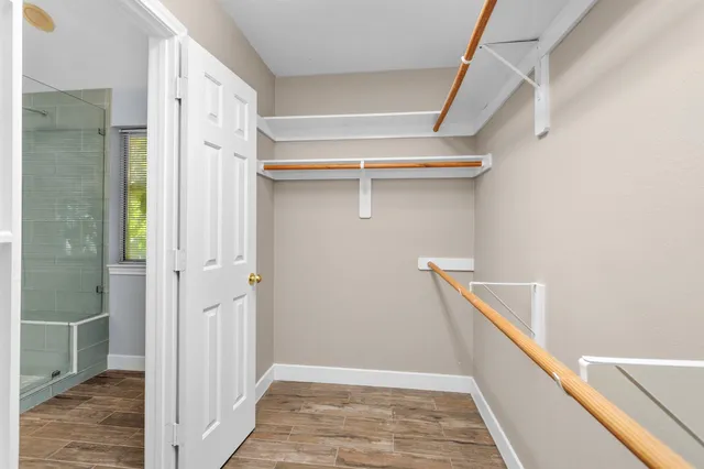 a view of hallway with stairs and wooden floor