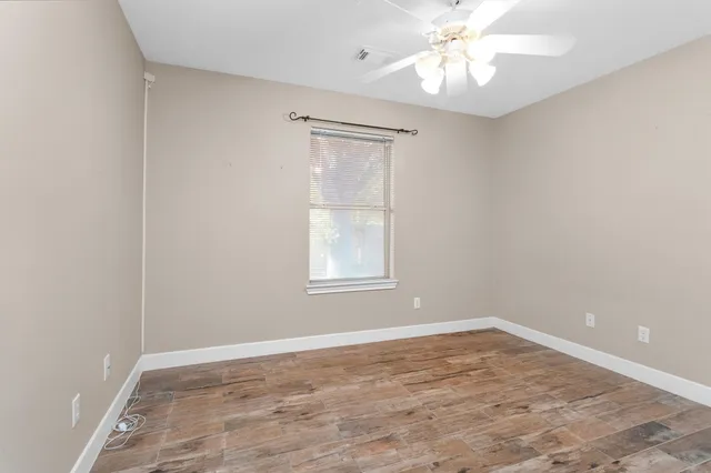 wooden floor in an empty room with a window