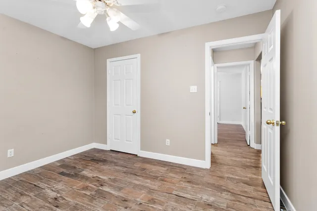 a view of an empty room with wooden floor