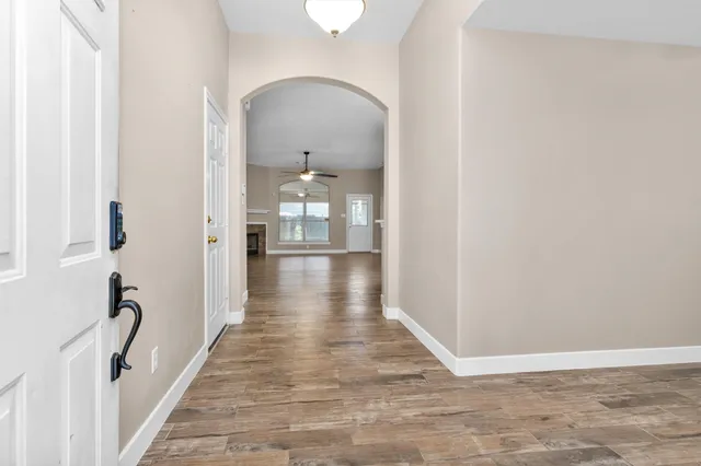a view of a hallway view with wooden floor and staircase