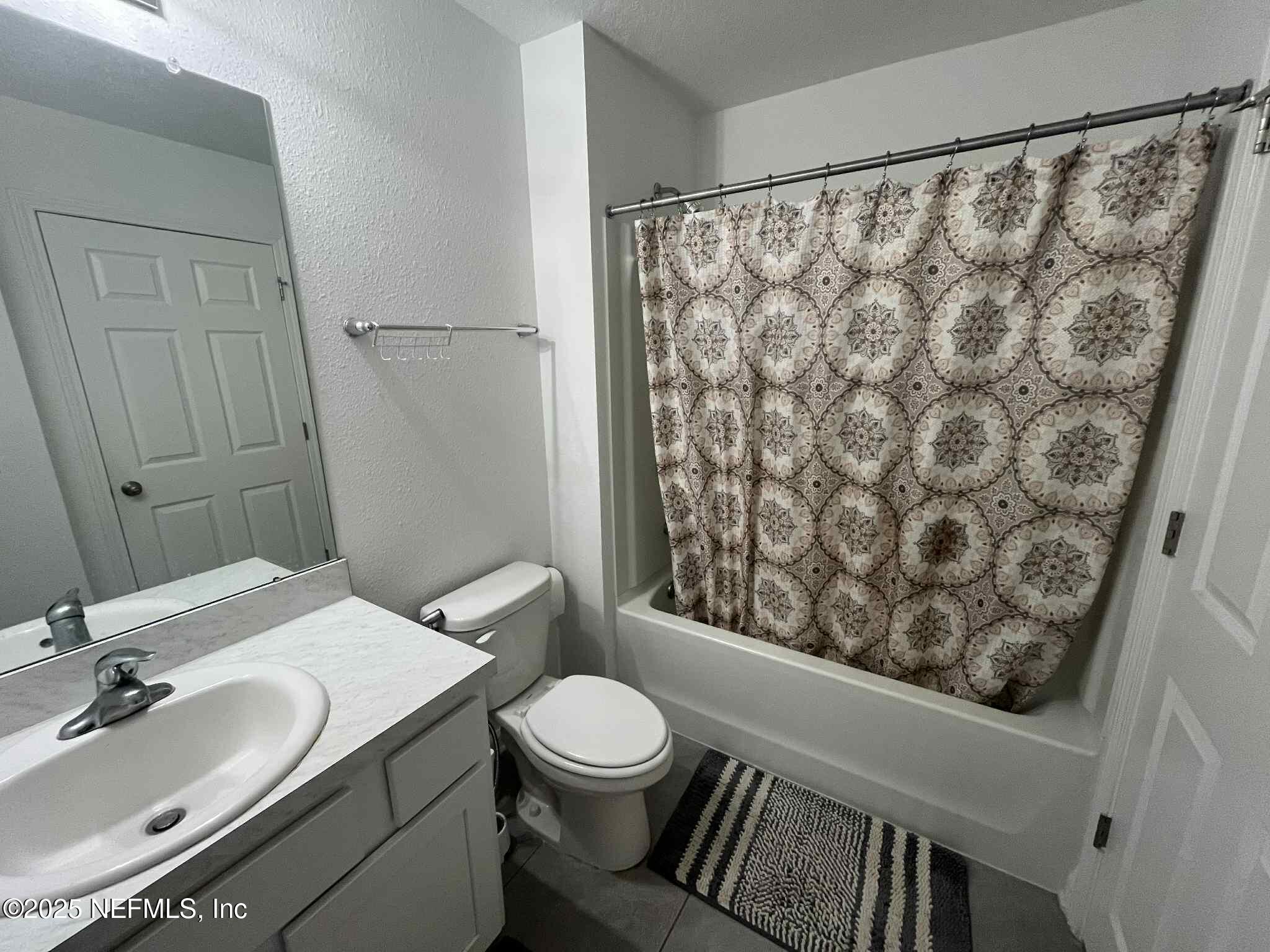 4935 Nebula Lane Jacksonville, FL 32256 - Photo 11 of 12 a bathroom with a granite countertop sink and a mirror