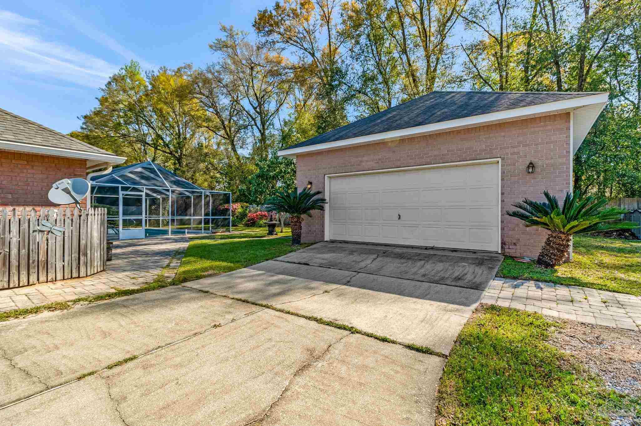 9320 Bell Ridge Drive Pensacola, FL 32526 - Photo 11 of 55 a front view of a house with a yard and garage