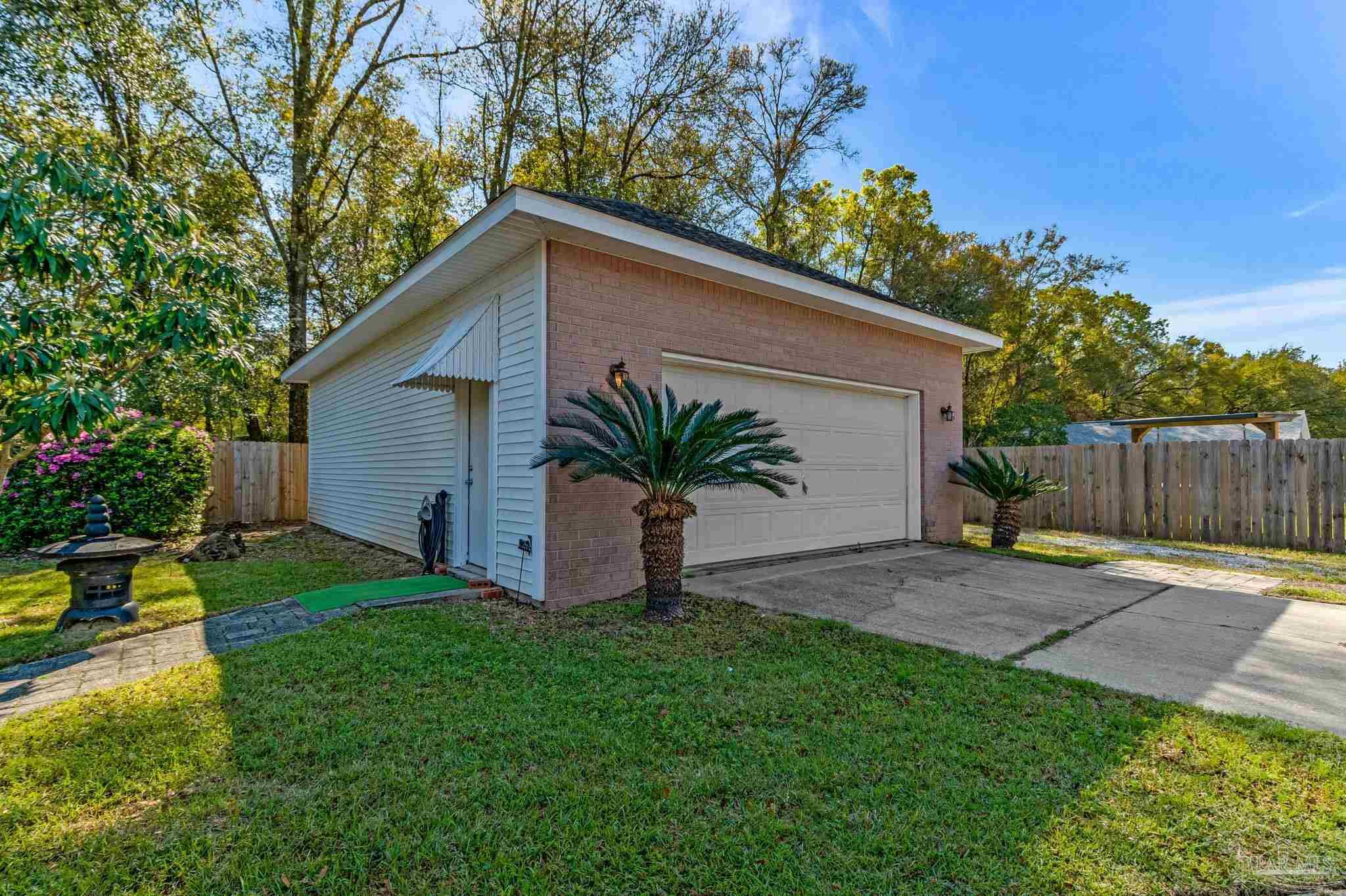 9320 Bell Ridge Drive Pensacola, FL 32526 - Photo 12 of 55 a view of a yard with a house and a tree