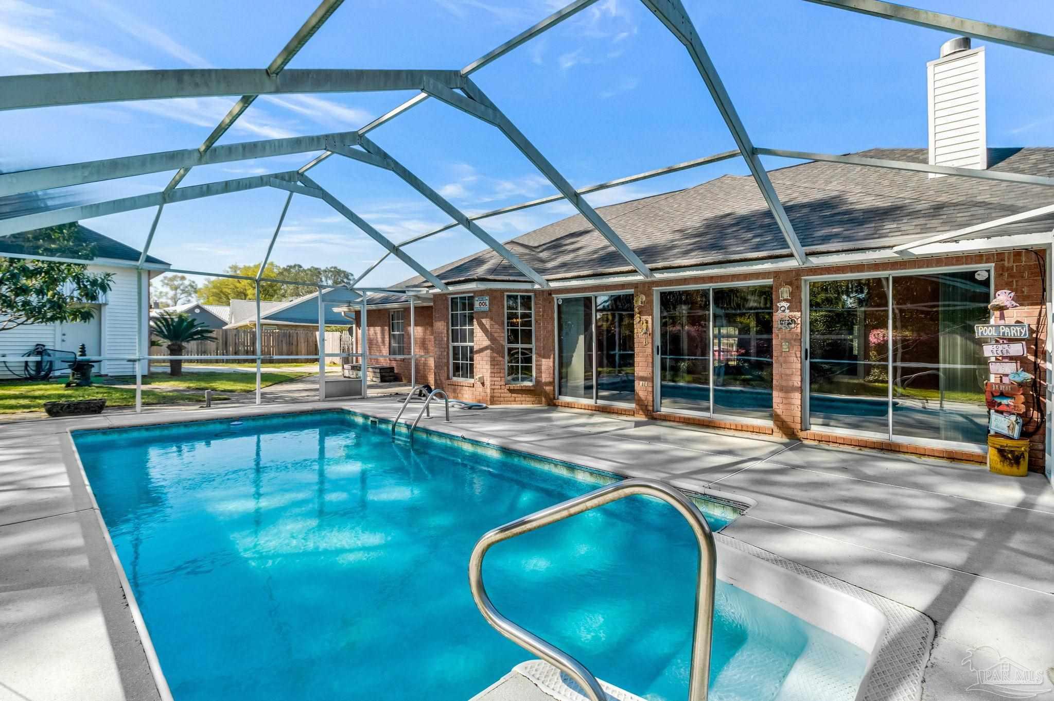 9320 Bell Ridge Drive Pensacola, FL 32526 - Photo 2 of 55 a view of a swimming pool with a patio