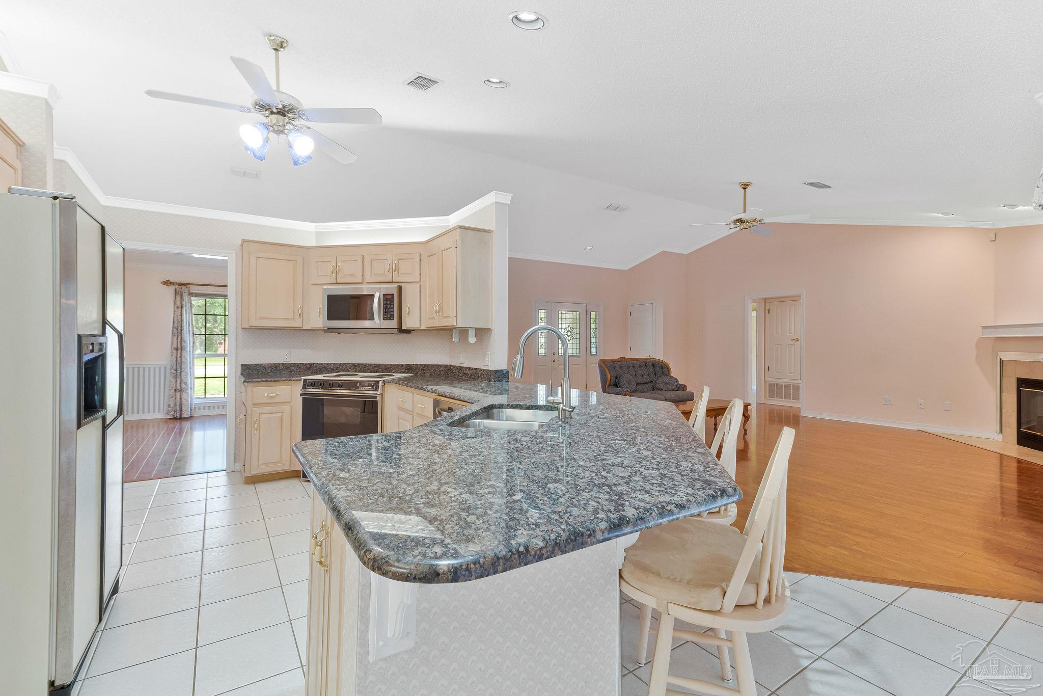 9320 Bell Ridge Drive Pensacola, FL 32526 - Photo 28 of 55 a kitchen with a table chairs and refrigerator