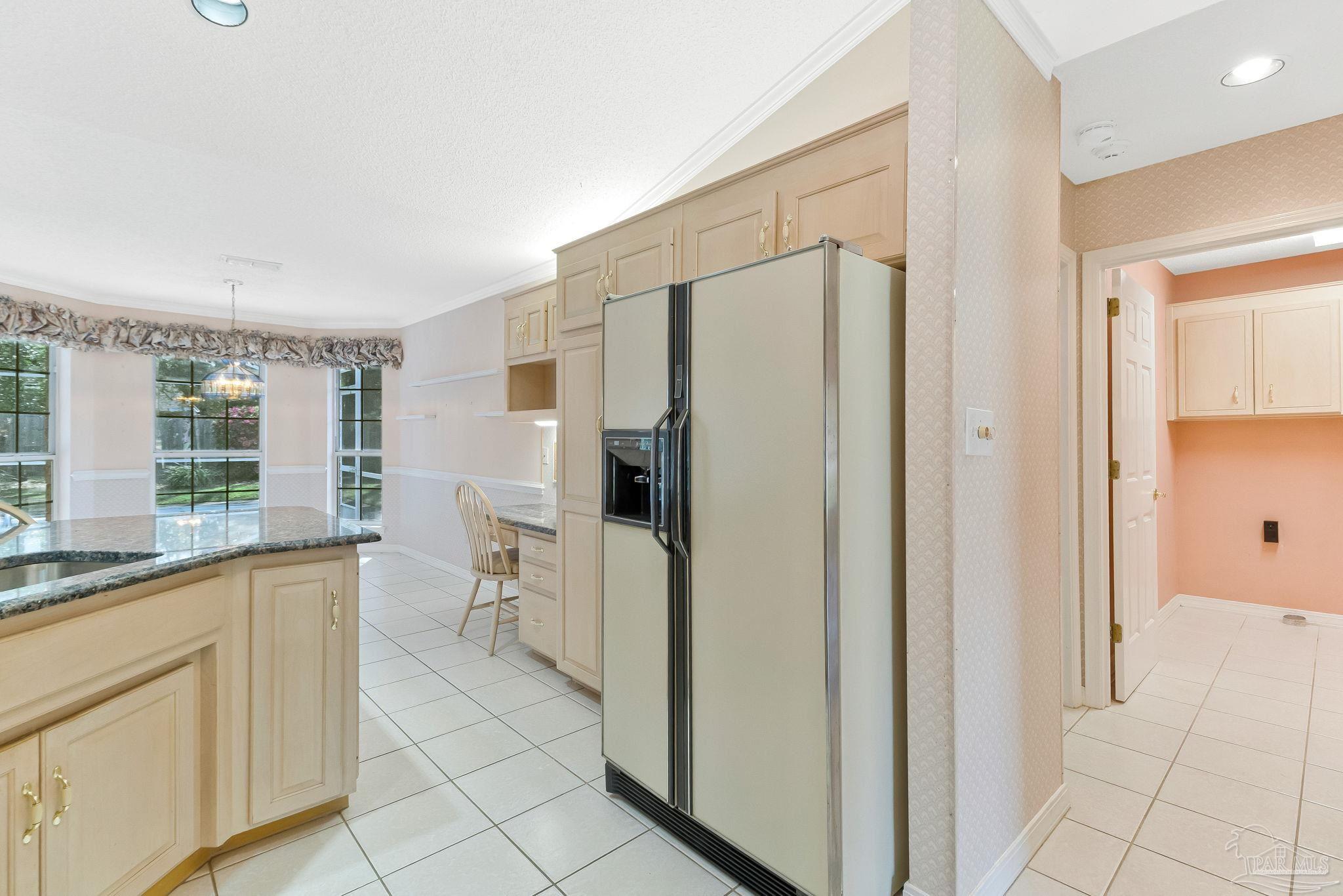 9320 Bell Ridge Drive Pensacola, FL 32526 - Photo 30 of 55 a kitchen with white cabinets and refrigerator