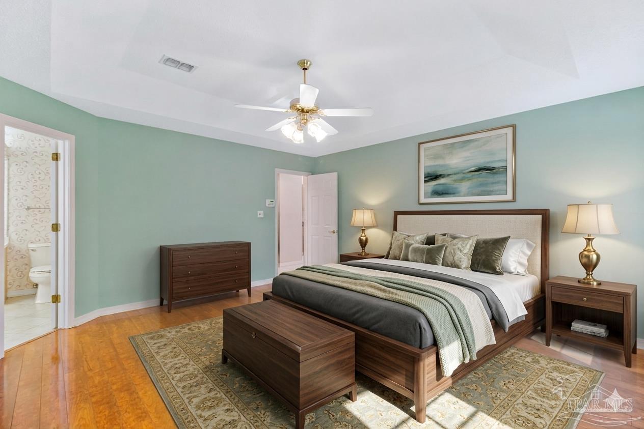 9320 Bell Ridge Drive Pensacola, FL 32526 - Photo 35 of 55 a bedroom with a bed and a chandelier