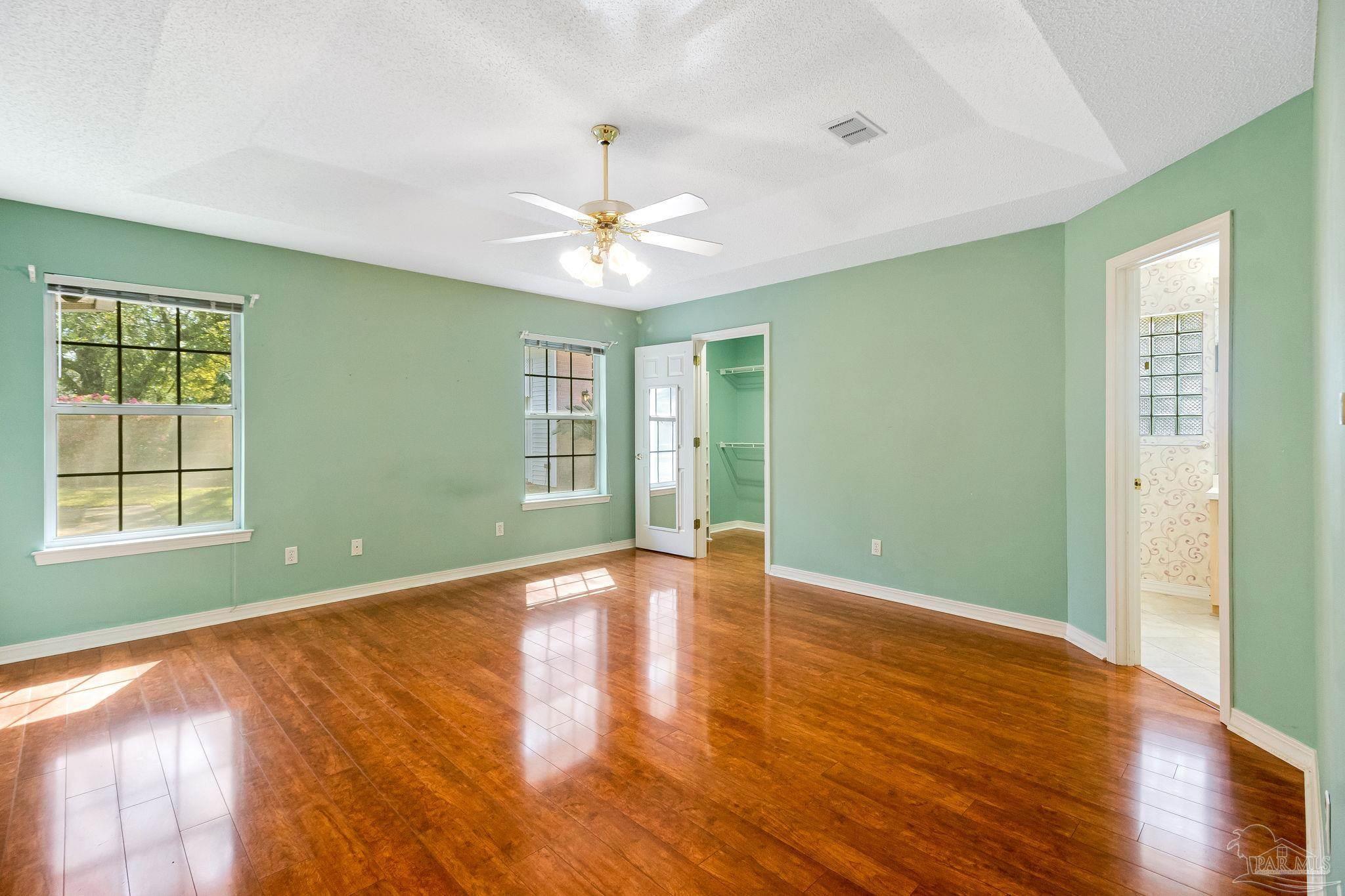 9320 Bell Ridge Drive Pensacola, FL 32526 - Photo 36 of 55 a view of an empty room with glass door and wooden floor