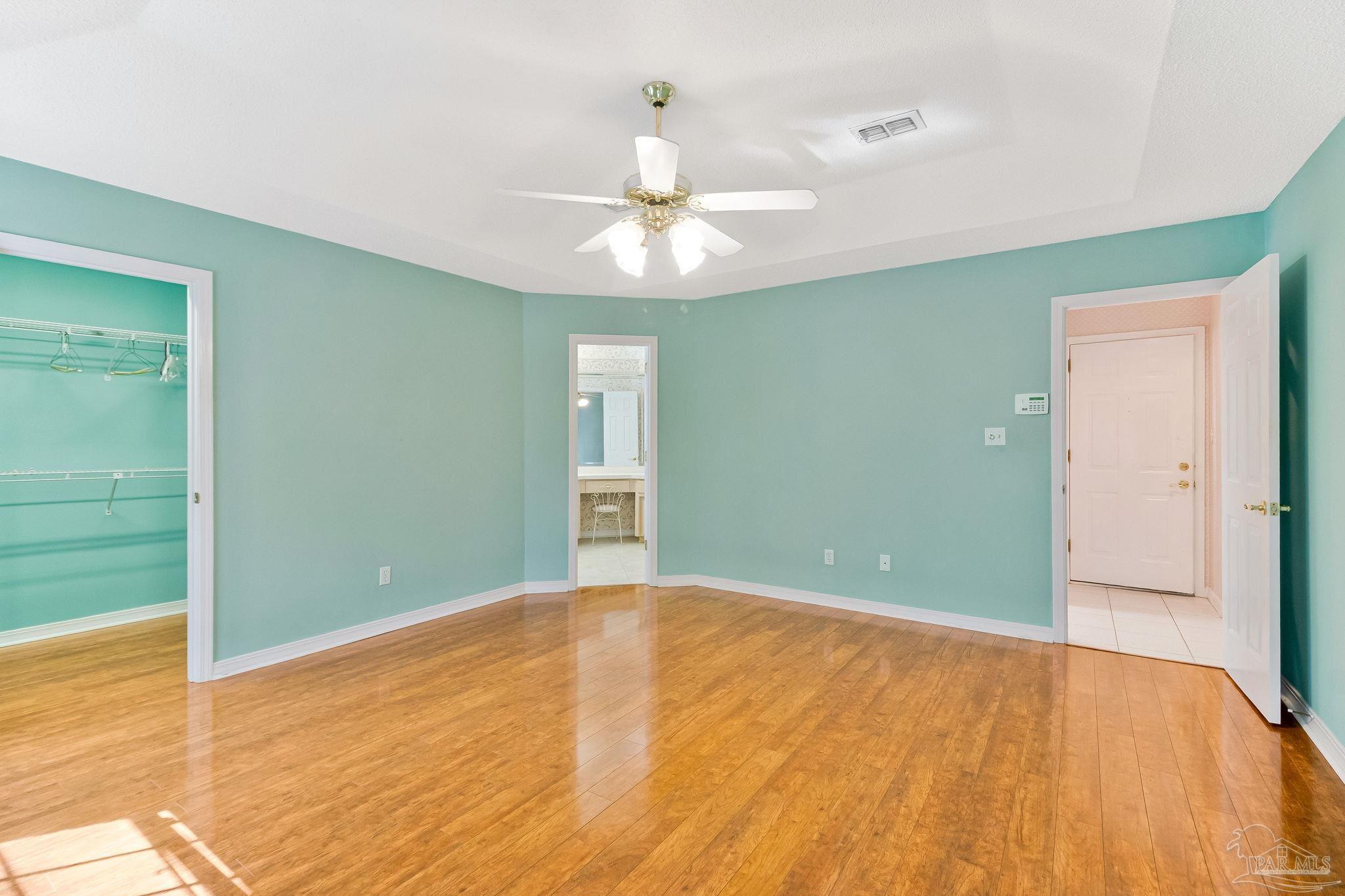 9320 Bell Ridge Drive Pensacola, FL 32526 - Photo 37 of 55 a view of an empty room with chandelier fan and a window