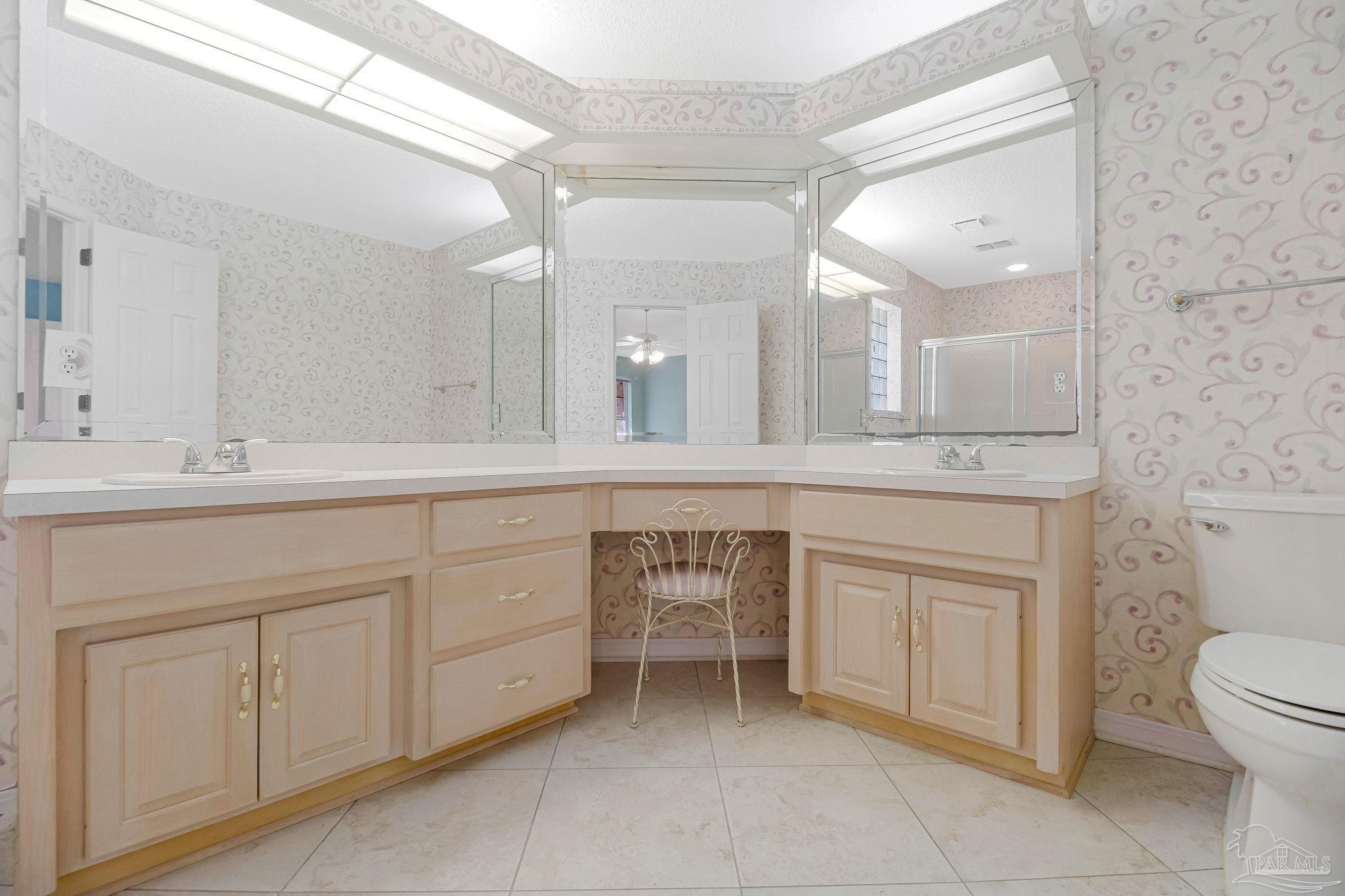 9320 Bell Ridge Drive Pensacola, FL 32526 - Photo 39 of 55 a spacious bathroom with a granite countertop sink a toilet mirror and bathtub