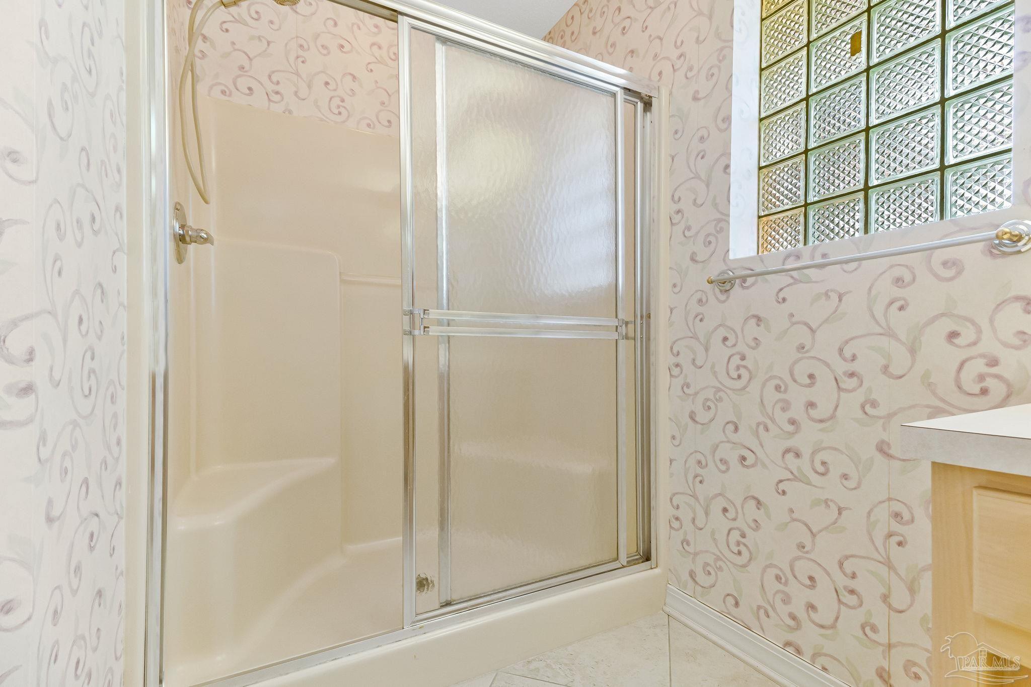 9320 Bell Ridge Drive Pensacola, FL 32526 - Photo 41 of 55 a bathroom with a glass shower door