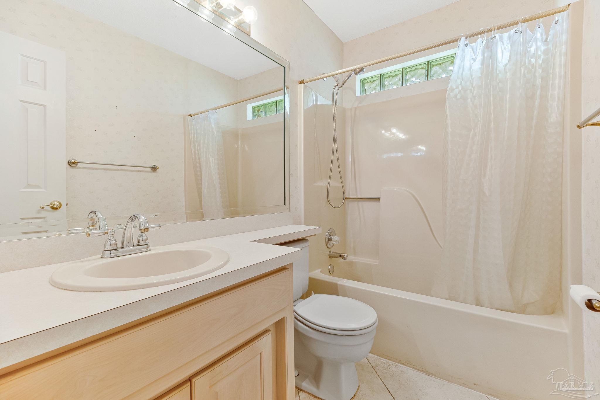 9320 Bell Ridge Drive Pensacola, FL 32526 - Photo 46 of 55 a bathroom with a sink a toilet and shower