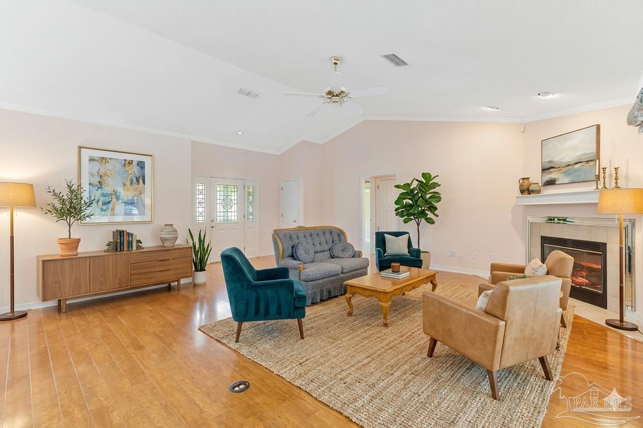 9320 Bell Ridge Drive Pensacola, FL 32526 - Photo 5 of 55 a living room with fireplace furniture and a wooden floor