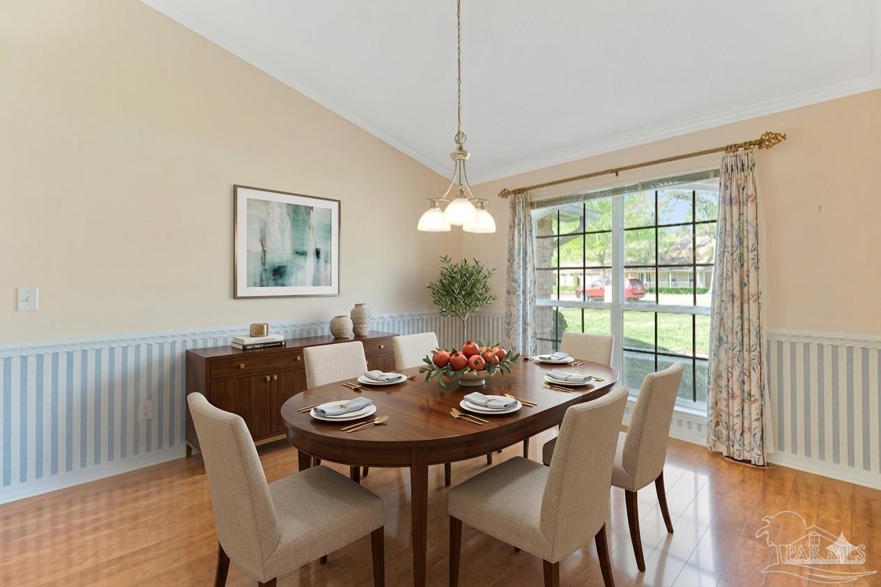 9320 Bell Ridge Drive Pensacola, FL 32526 - Photo 6 of 55 a dining room with furniture a rug and wooden floor