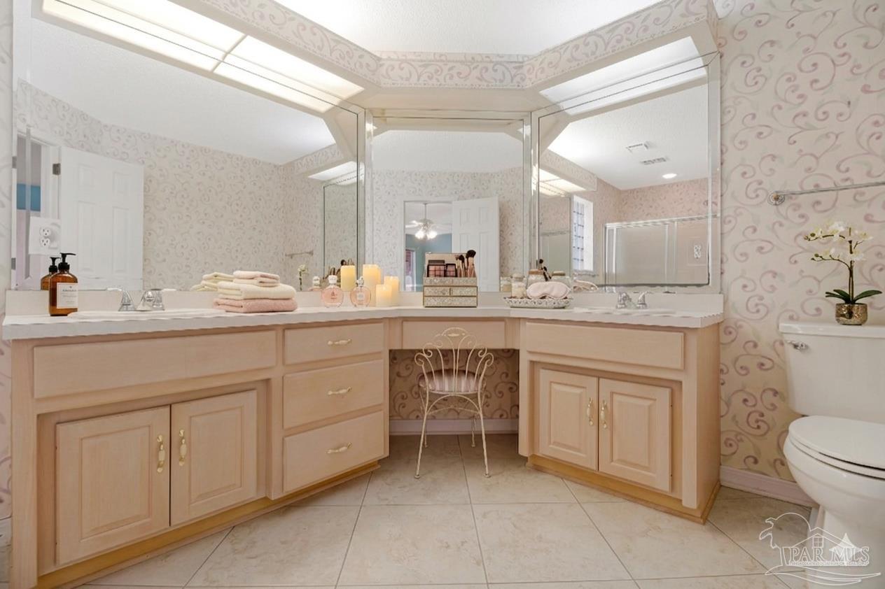 9320 Bell Ridge Drive Pensacola, FL 32526 - Photo 7 of 55 a bathroom with a sink a toilet and a mirror