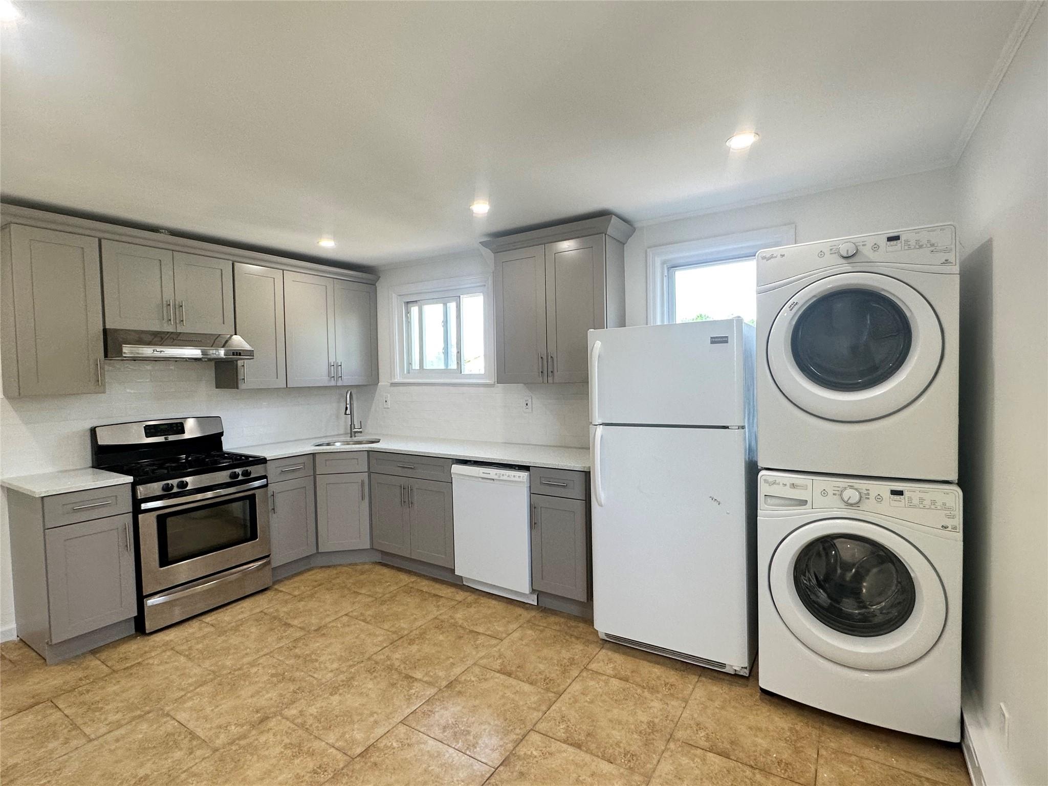 Undisclosed Address New Hyde Park, NY 11040 - Photo 1 of 1 a kitchen with a stove top oven sink and cabinets