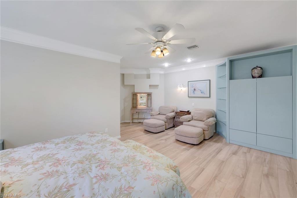 2147 Snook Drive Naples, FL 34102 - Photo 15 of 50 Bedroom with light wood finished floors, a ceiling fan, crown molding, and recessed lighting
