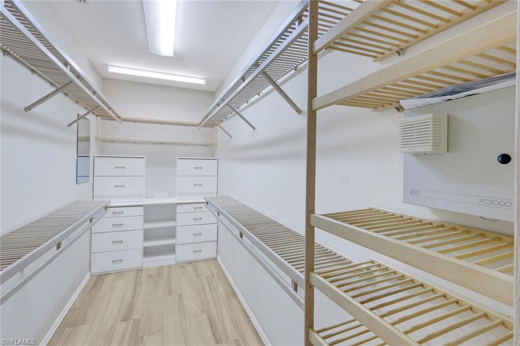 2147 Snook Drive Naples, FL 34102 - Photo 16 of 50 Walk in closet with light wood-style floors