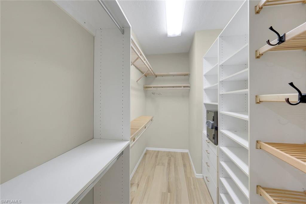 2147 Snook Drive Naples, FL 34102 - Photo 17 of 50 Walk in closet with light wood-style flooring