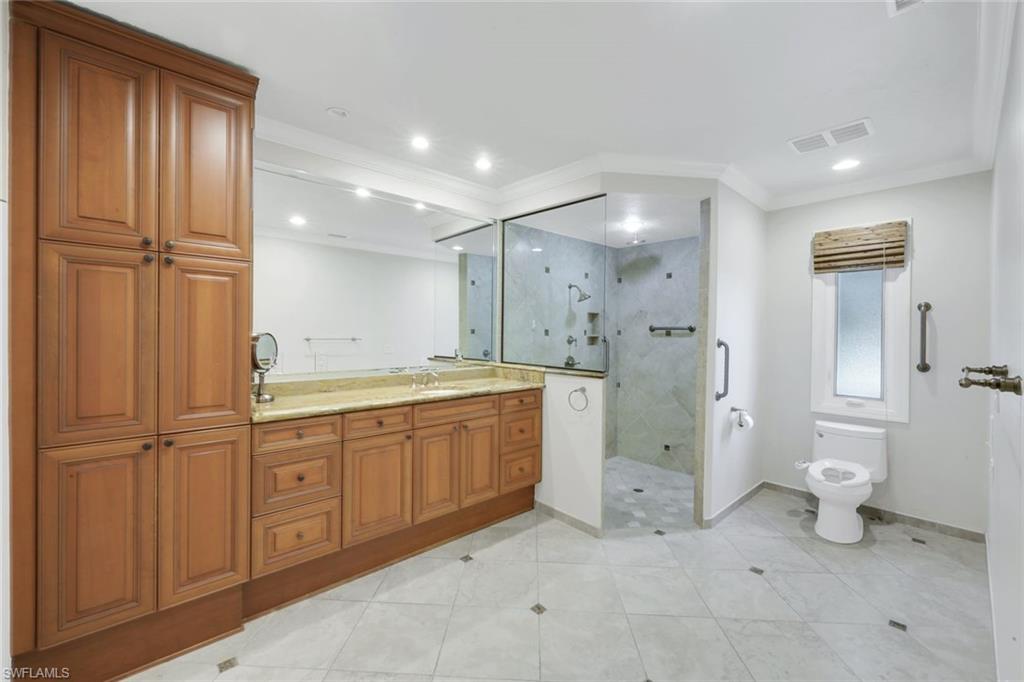 2147 Snook Drive Naples, FL 34102 - Photo 19 of 50 Full bathroom with vanity, a stall shower, ornamental molding, light tile patterned floors, and recessed lighting
