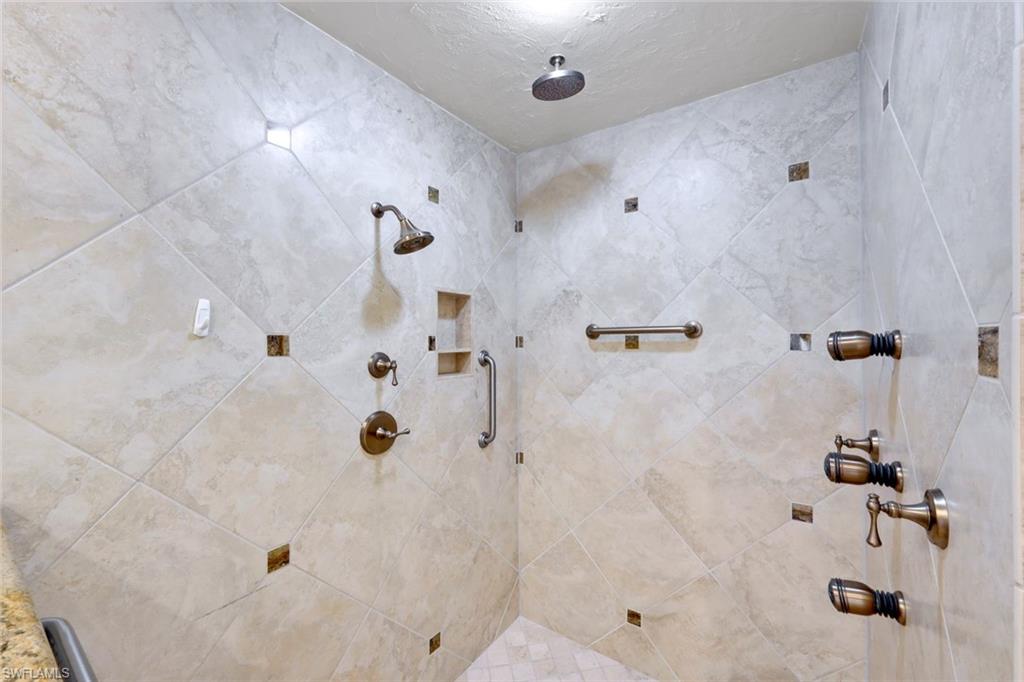 2147 Snook Drive Naples, FL 34102 - Photo 20 of 50 Bathroom featuring a tile shower