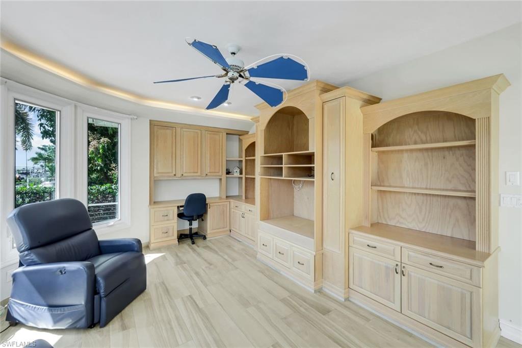 2147 Snook Drive Naples, FL 34102 - Photo 22 of 50 Office area featuring built in study area, ceiling fan, and light wood-style floors