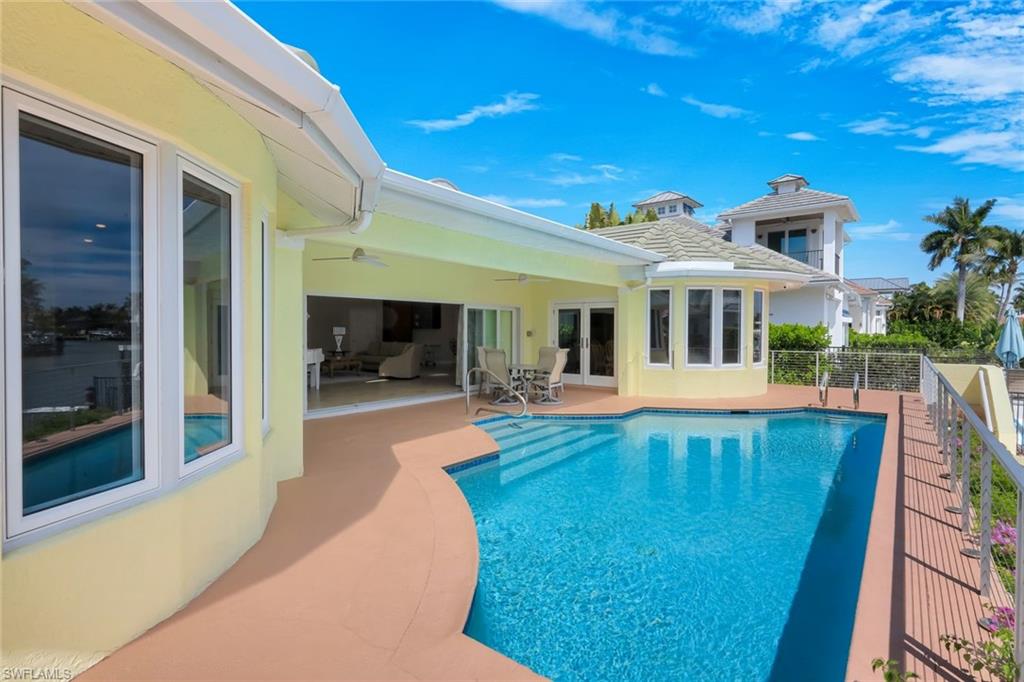 2147 Snook Drive Naples, FL 34102 - Photo 31 of 50 View of swimming pool featuring french doors and patio surround
