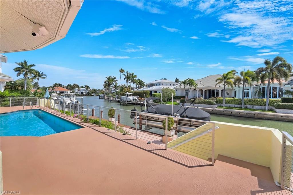 2147 Snook Drive Naples, FL 34102 - Photo 32 of 50 View of swimming pool with a water view, a boat dock, and a residential view