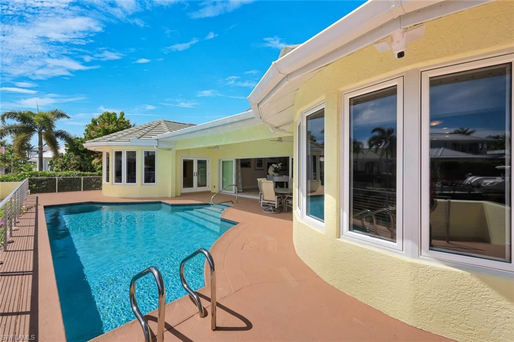 2147 Snook Drive Naples, FL 34102 - Photo 33 of 50 View of pool featuring patio surround and french doors