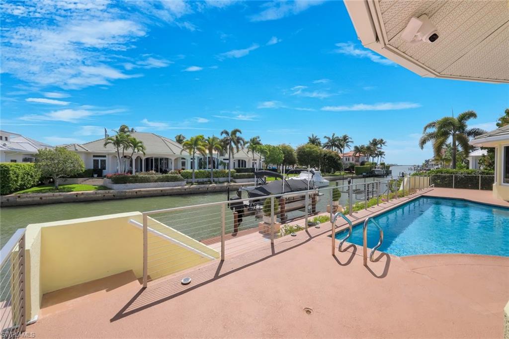 2147 Snook Drive Naples, FL 34102 - Photo 34 of 50 View of pool featuring patio surround and a residential view
