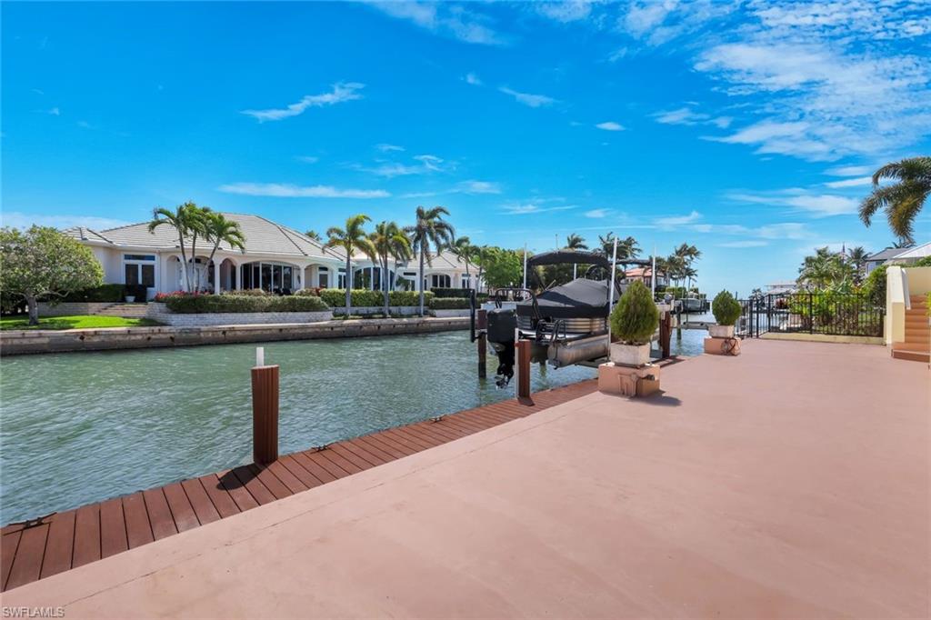 2147 Snook Drive Naples, FL 34102 - Photo 35 of 50 Dock with boat lift, a water view, and a residential view