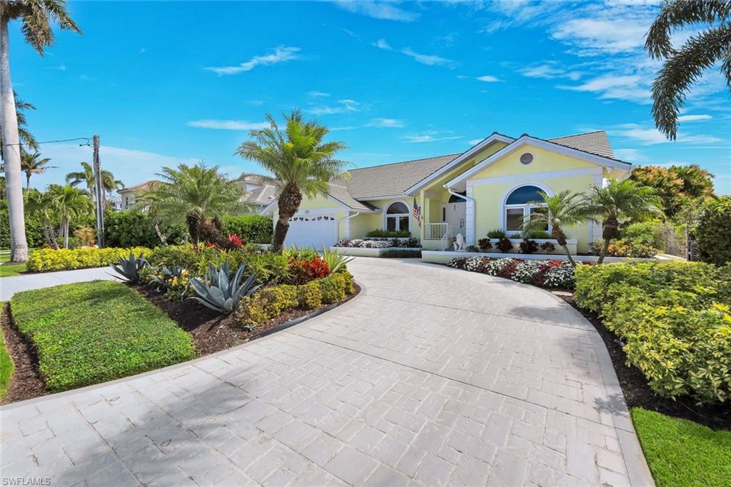 2147 Snook Drive Naples, FL 34102 - Photo 41 of 50 Ranch-style house with driveway, stucco siding, and a garage