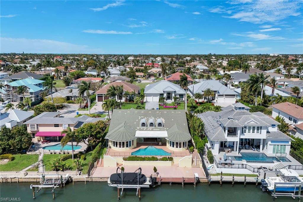 2147 Snook Drive Naples, FL 34102 - Photo 43 of 50 Aerial perspective of suburban area featuring a pool area and a large body of water