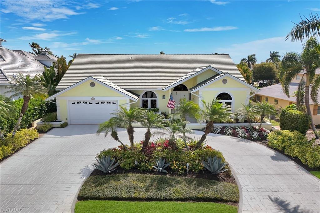 2147 Snook Drive Naples, FL 34102 - Photo 45 of 50 Ranch-style house with driveway, a tile roof, a garage, and stucco siding