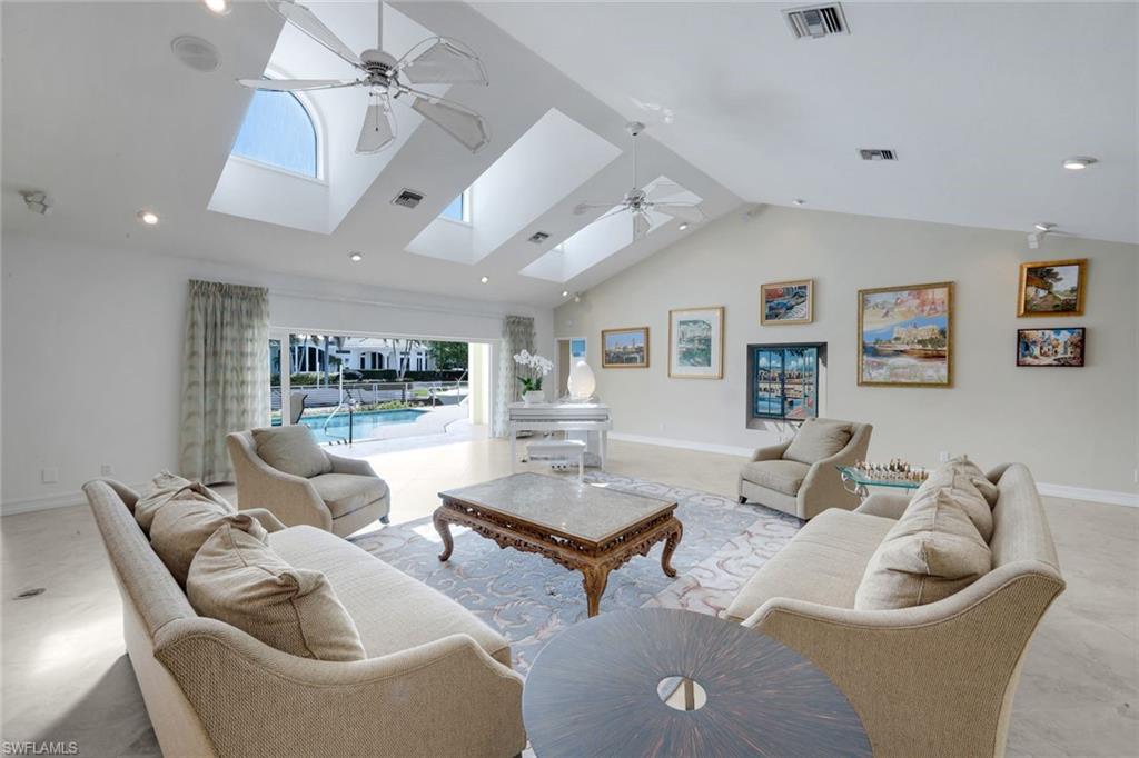 2147 Snook Drive Naples, FL 34102 - Photo 5 of 50 Living area featuring a ceiling fan, a high ceiling, and recessed lighting