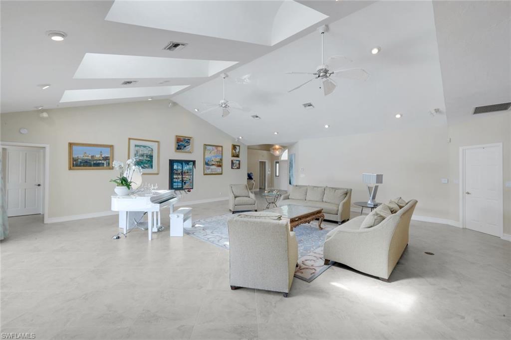 2147 Snook Drive Naples, FL 34102 - Photo 6 of 50 Living area featuring a high ceiling, a skylight, a ceiling fan, and recessed lighting