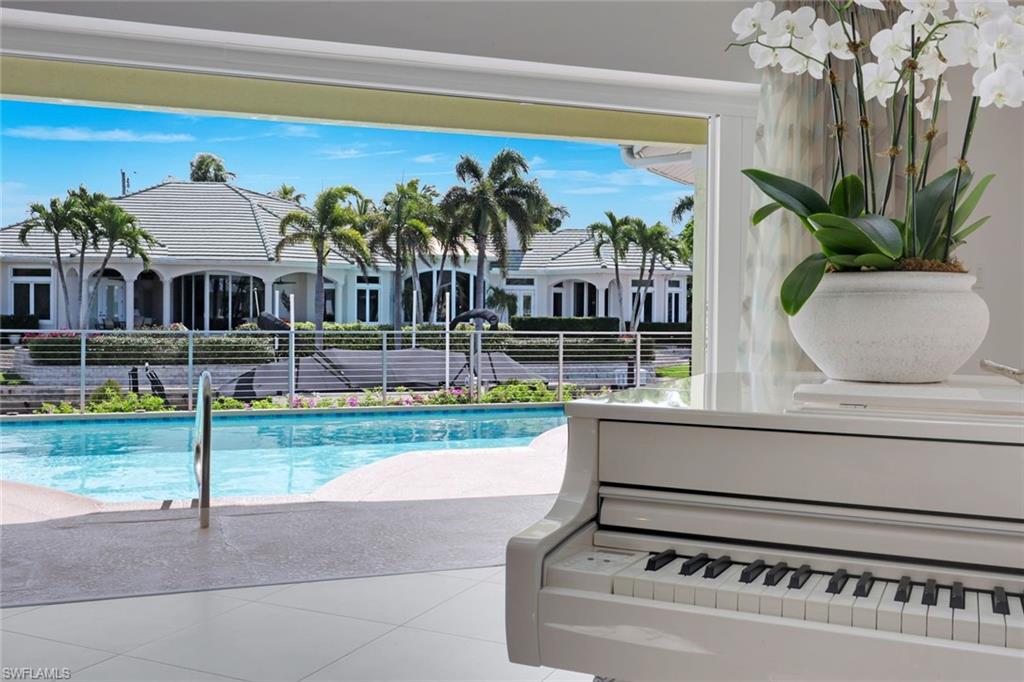 2147 Snook Drive Naples, FL 34102 - Photo 8 of 50 View of pool featuring patio surround